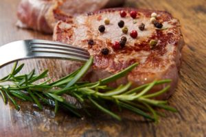 Rosmarinzweig an Fleisch